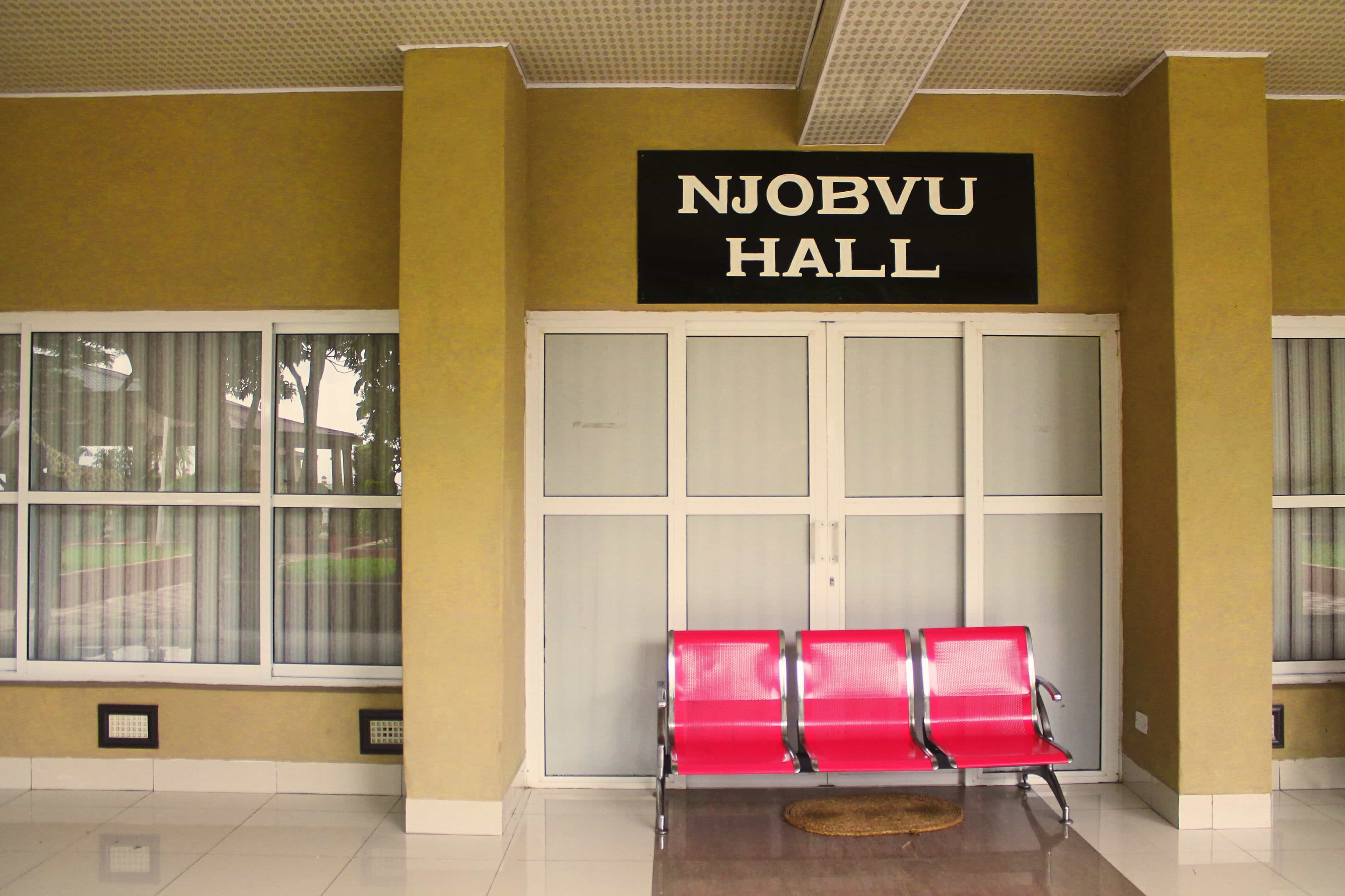 front view of njobvu hall entrance with sign and red chairs