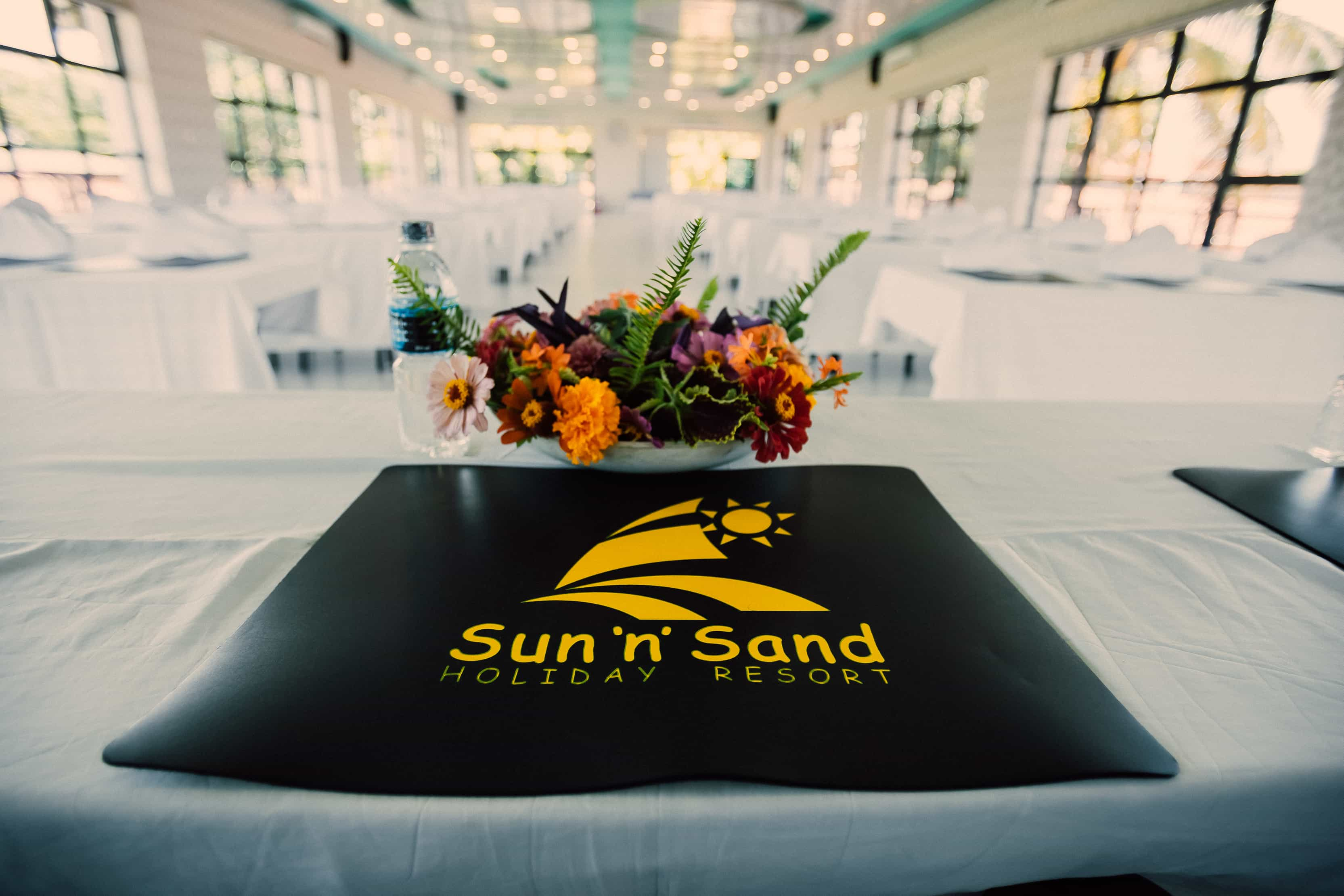 close up of mat with sun n sand logo and flower