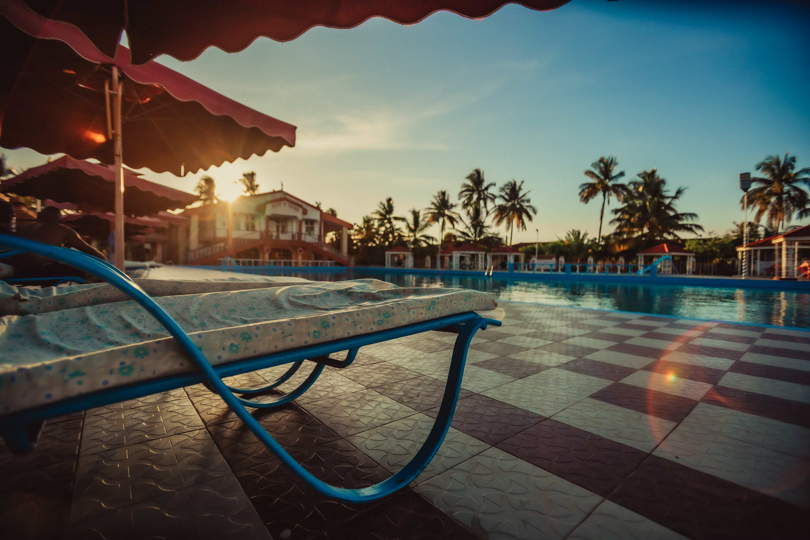 close up beach bed with view of swimming pool