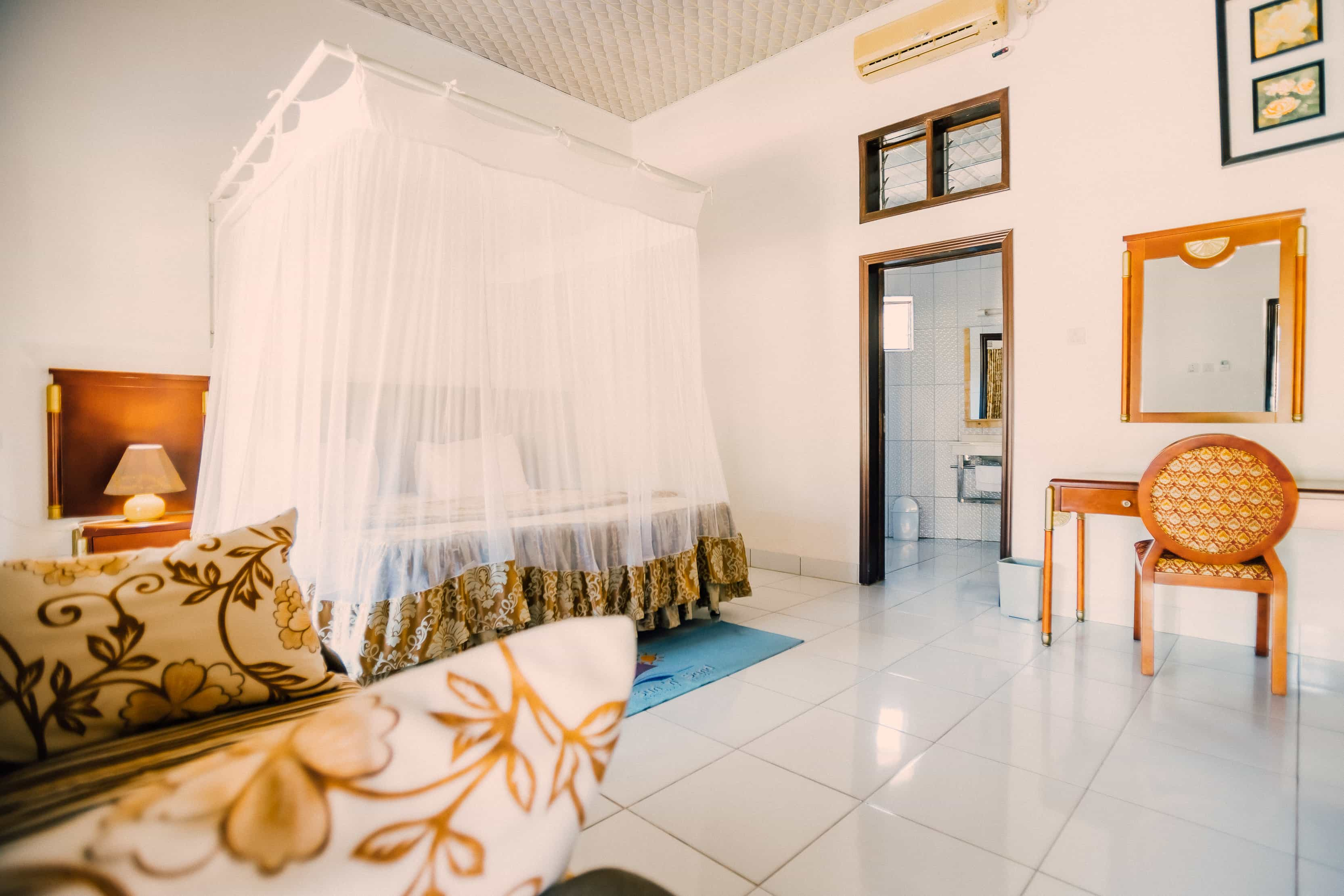 inside view of room with double bed dresser and bathroom in view