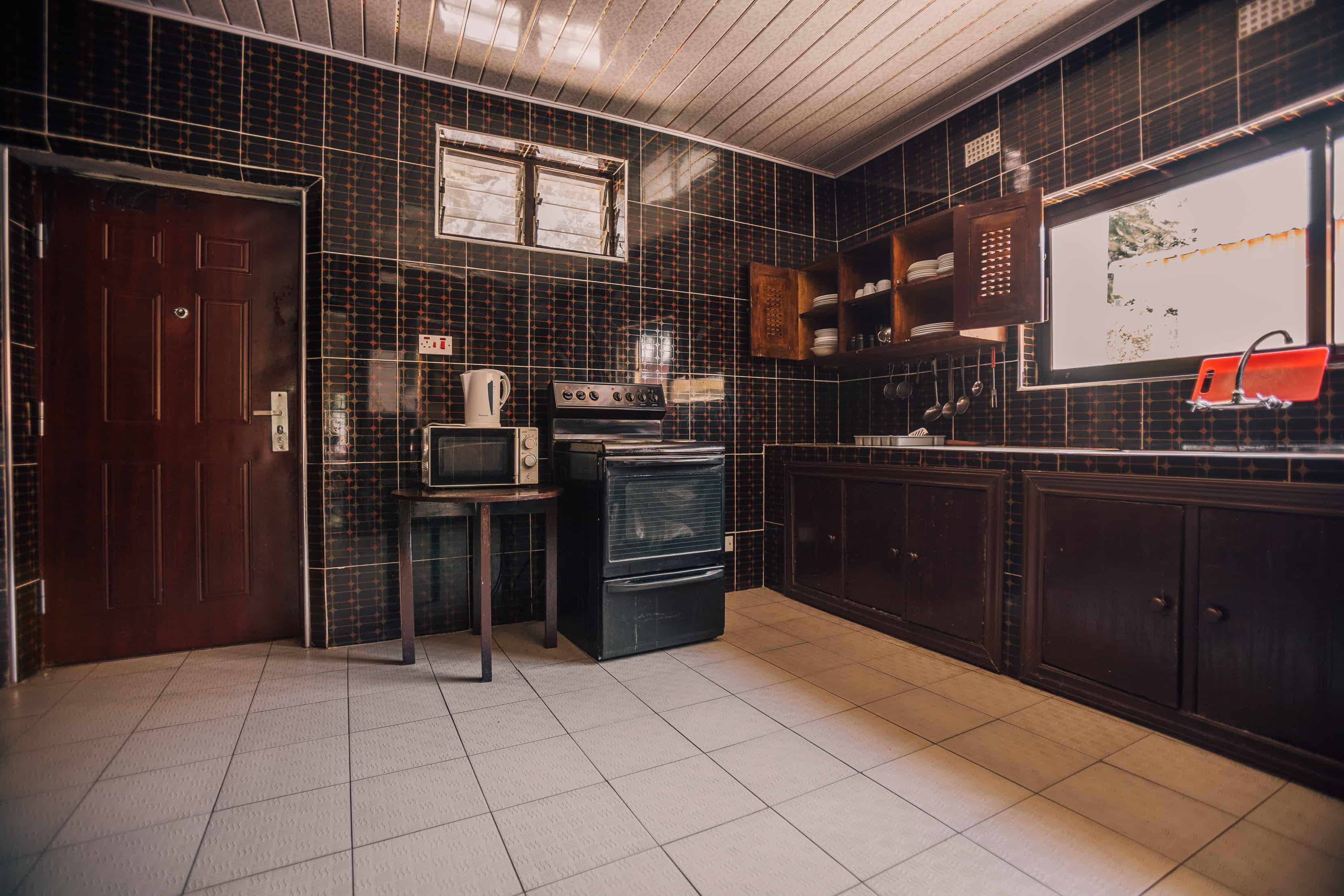 inside view of kitchen with stove microwave kitchenware