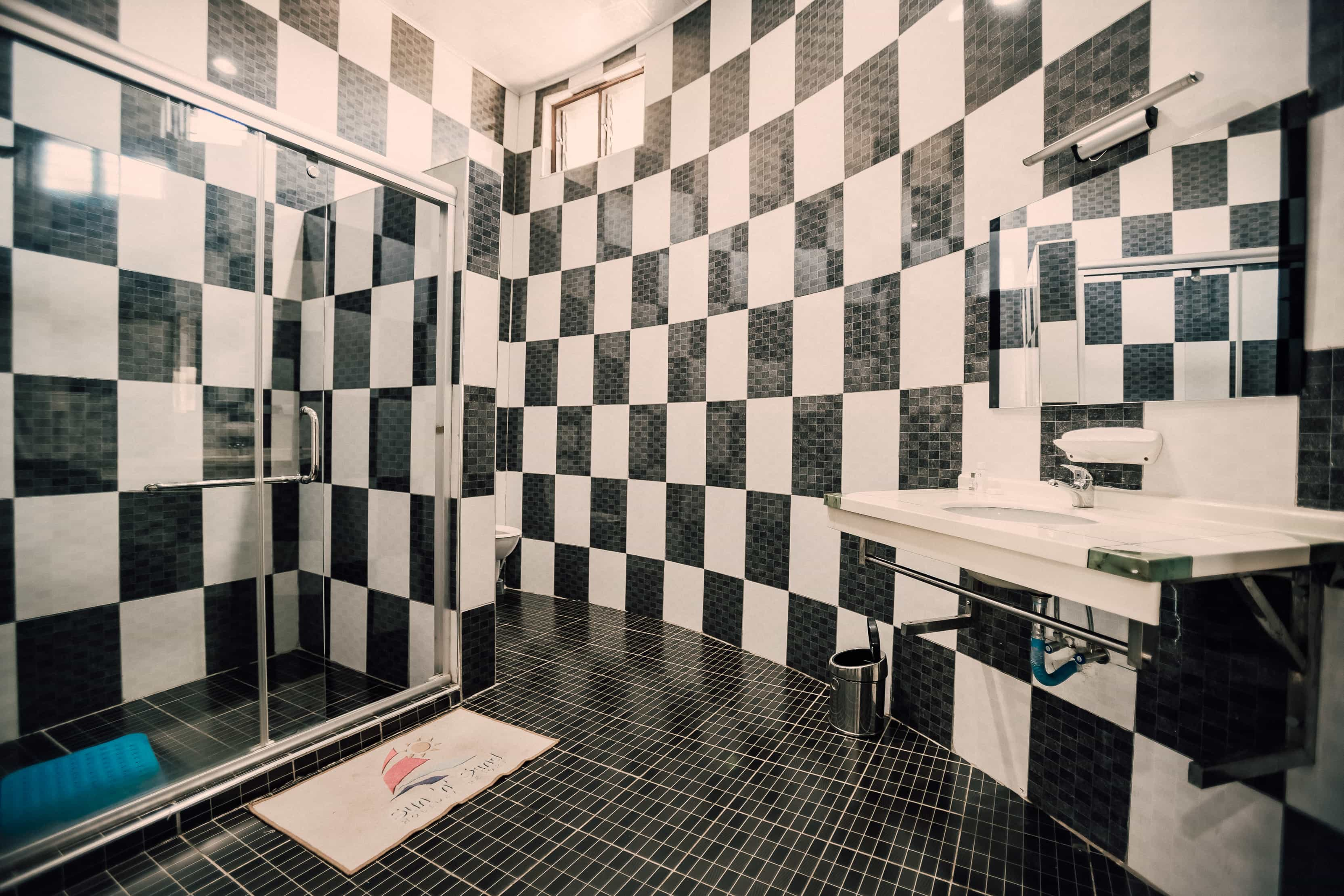 angle view of bathroom with sink and shower