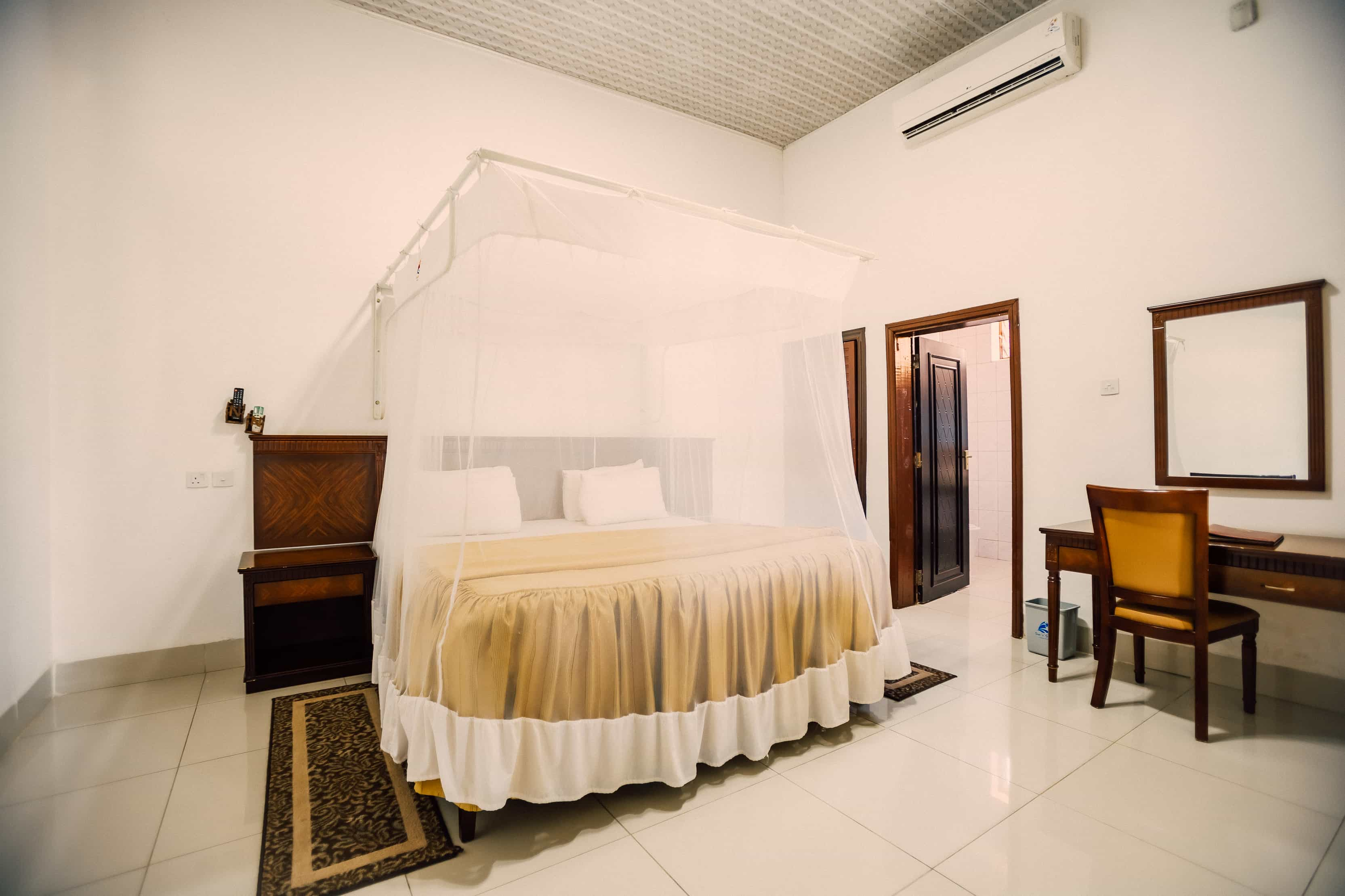 view of bedroom with dress and bathroom